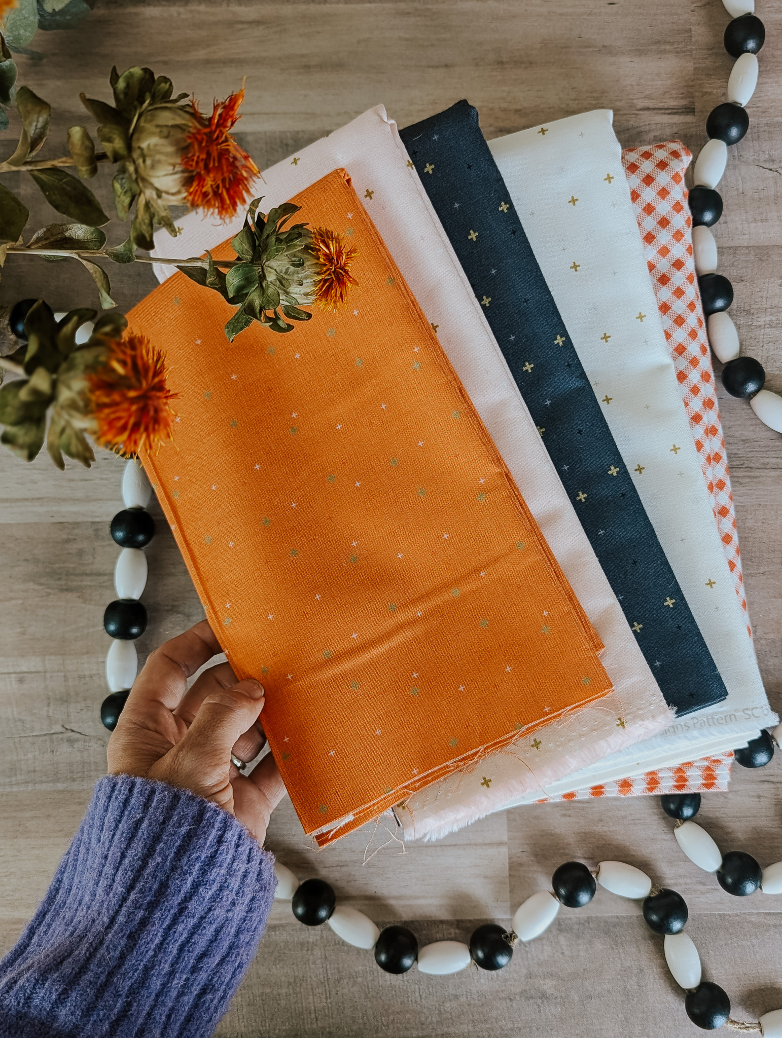 Sparkler fabrics in Pumpkin, Ballerina, Charcoal, and Vintage White. 