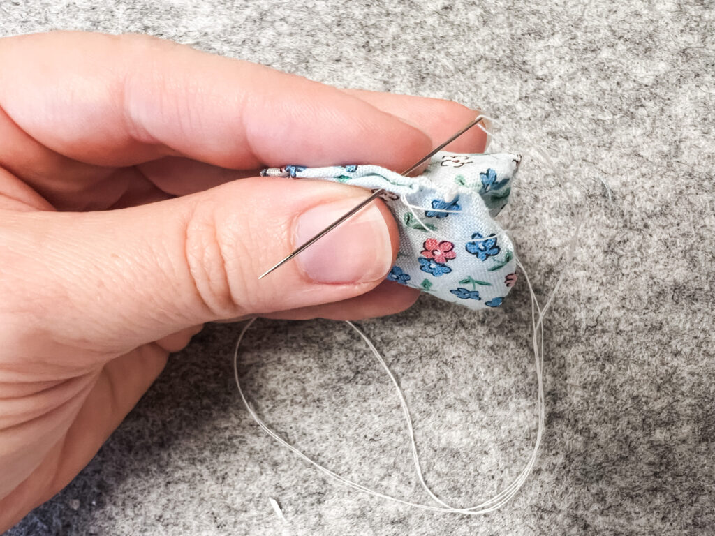 Hand stitching 2 yo-yos together.