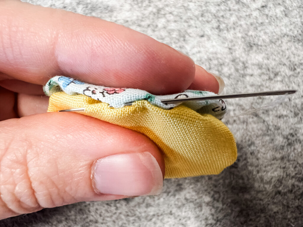 Detail of Ladder stitching 2 yo-yos together by hand.