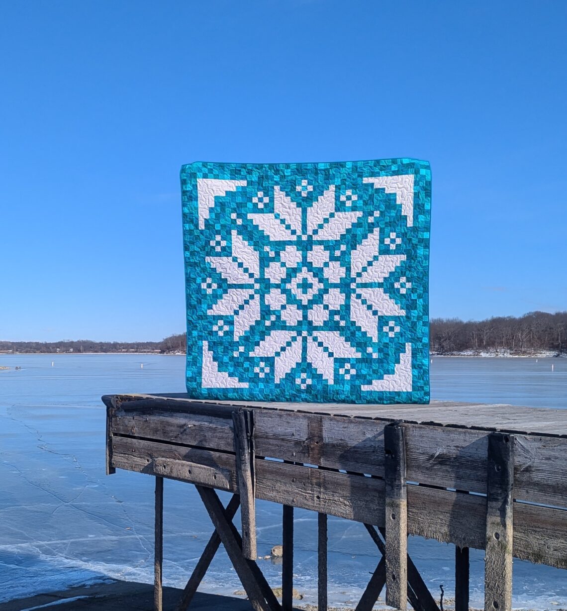 Early Bloomer pixel quilt made with solid turquoise fabrics and the Lights On II collection of white-on-white fabrics by Riley Blake Designs