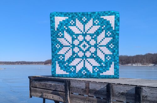 Early Bloomer pixel quilt made with solid turquoise fabrics and the Lights On II collection of white-on-white fabrics by Riley Blake Designs